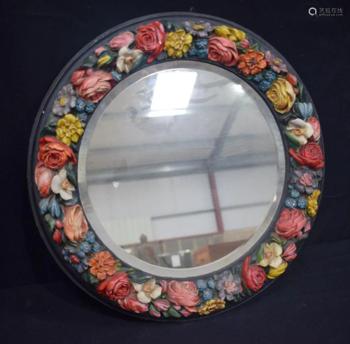 A large antique wooden mirror with a surround of