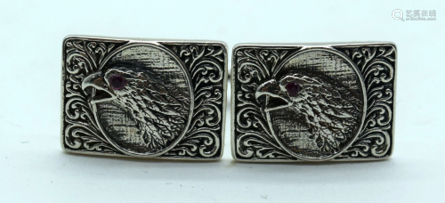 A pair of sterling silver cufflinks in the form of