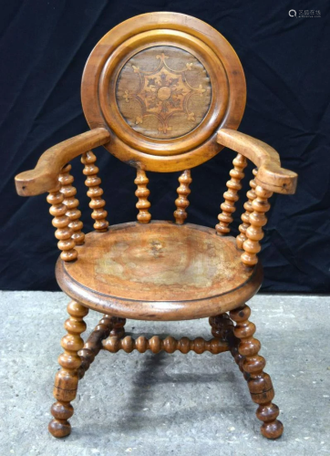 An antique wooden child's chair with inlaid wooden