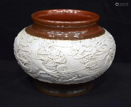 A large Chinese porcelain jar decorated in relief with