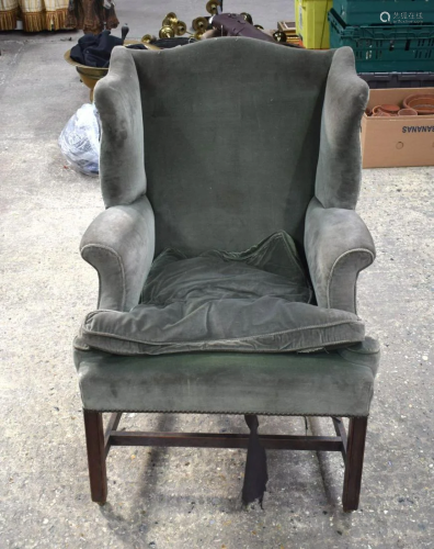 An antique upholstered wing back chair. 97 x 58 x 57cm.