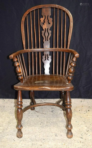 A 19th century wooden Windsor chair. 106 x 55cm