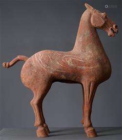 A LARGE CHINESE RED POTTERY HORSE  HAN DYNASTY (202BC-220AD)