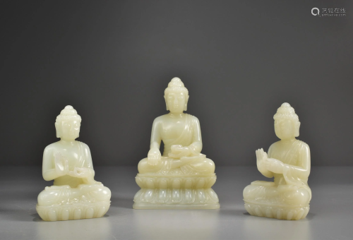 A GROUP OF THREE WHITE JADE BUDDHA STATUES