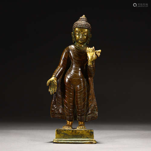 Ancient bronze statue of the Standing Buddha