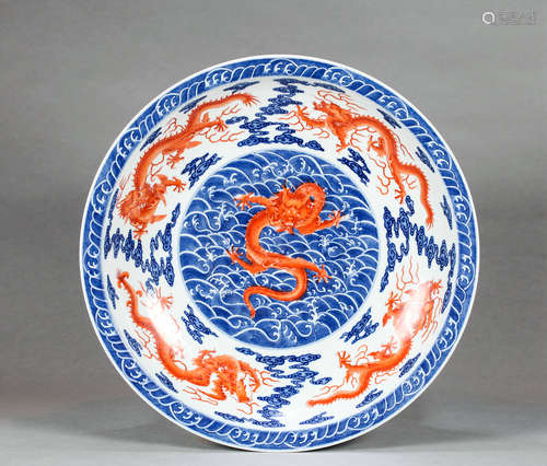 AN UNDERGLAZE BLUE AND IRON RED DRAGON PLATE, WITH