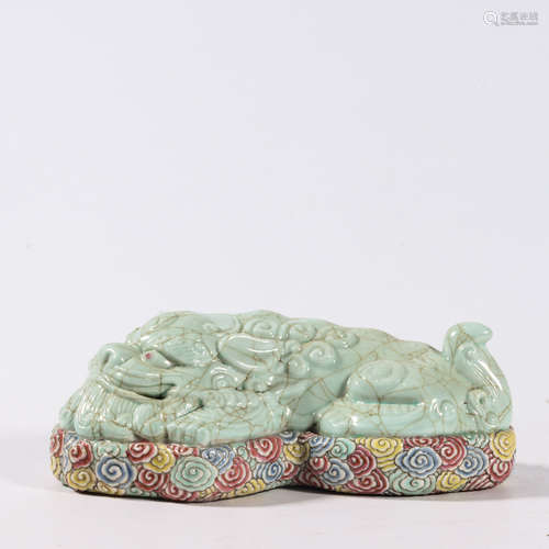 A CELADON GLAZE ‘LION’ PAPER WEIGHT