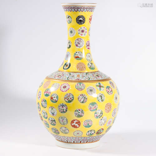 A YELLOW GROUND FAMILLE ROSE ‘FLOWER’ BOTTLE VASE