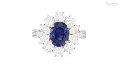 A SAPPHIRE AND DIAMOND CLUSTER RING The oval-shaped