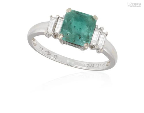 AN EMERALD AND DIAMOND DRESS RING The central