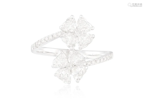 A DIAMOND FLOWER RING Composed of two flowerheads set