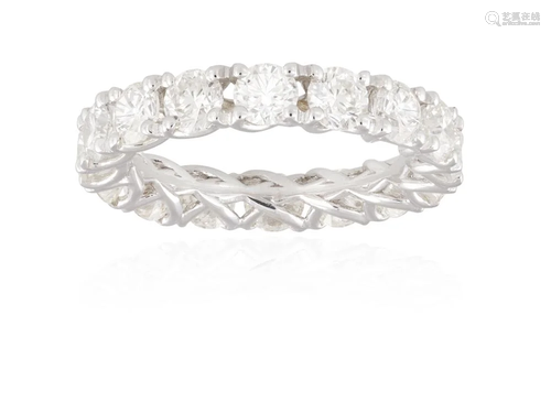 A DIAMOND ETERNITY RING Composed of a continuous row of