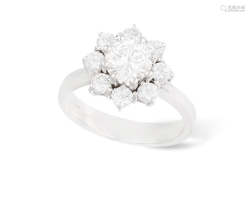 A DIAMOND CLUSTER RING The central brilliant-cut