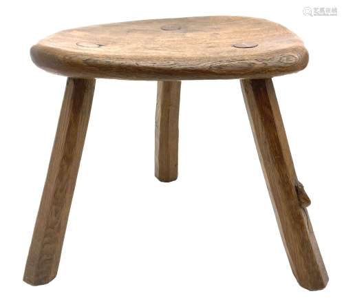 ‘Mouseman’ oak stool with shaped dished top on three tapered...