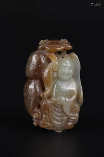 CARVED BROWNISH JADE FIGURE OF KID