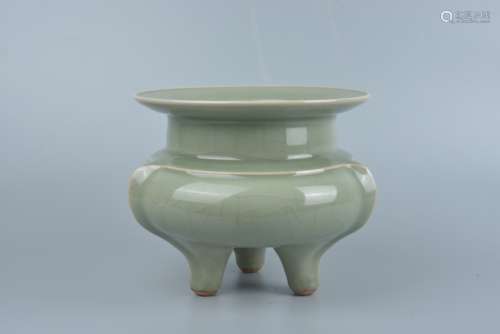 A three-legged celadon stove