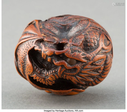 A Japanese Carved Wood Dragon and Leaf Netsuke,