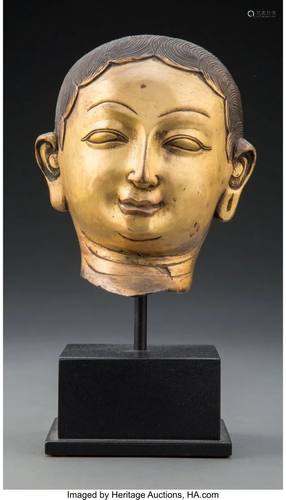 A Gilt Repousse Head of a Lama 8 x 4-1/4 x 5-1/4