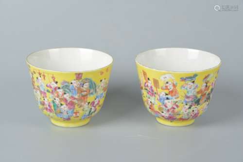 A pair of yellow ground pastel story cups