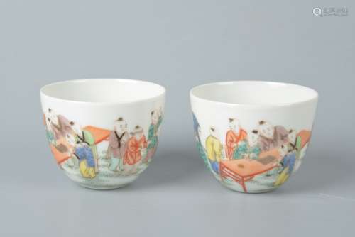 A pair of pastel cups with storytelling figures