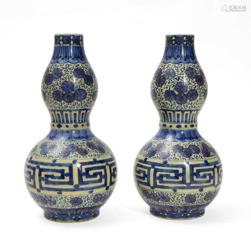 A pair of yellow-glazed blue and white gourd-shaped bottles,...