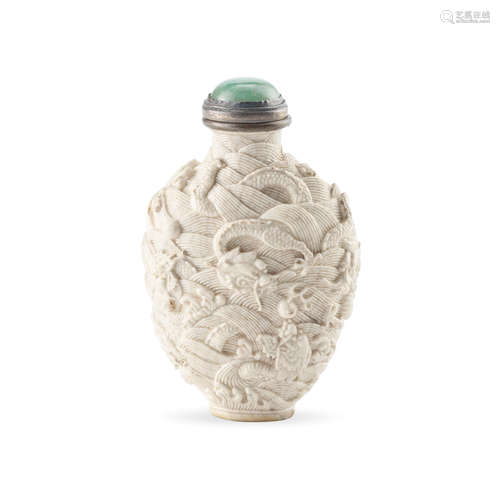 A molded and carved white-glazed 'nine-dragon' soft-paste po...