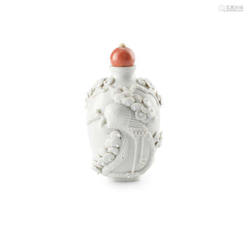 A rare high-relief-molded white porcelain snuff bottle