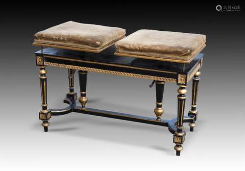 † A NAPOLEON III EBONISED AND PARCEL GILT DUET STOOL, CIRCA ...