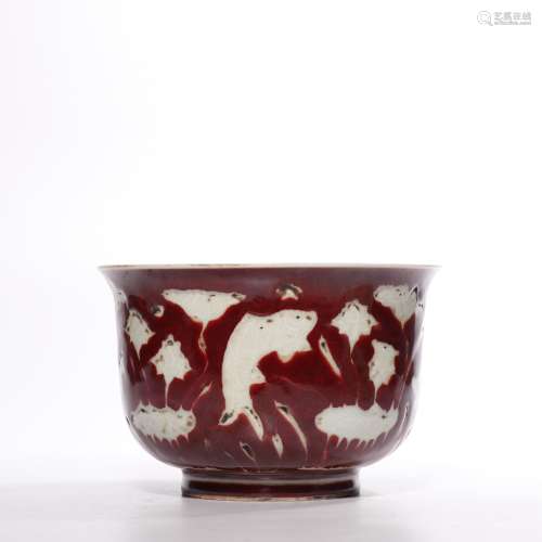A red glazed 'fish and waterseeds' bowl