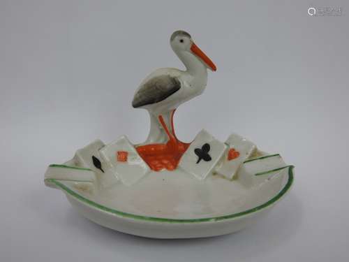 SALERON en porcelaine à décor d'une cigogne. Haut : 7cm. Mar...