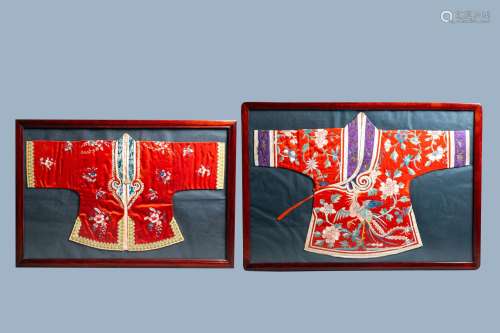 Two framed Chinese embroidered silk children's robes with fl...