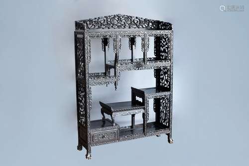 A Chinese open worked wooden display cabinet with floral des...