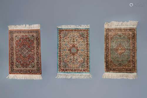 Three Oriental rugs with floral design and a central medalli...