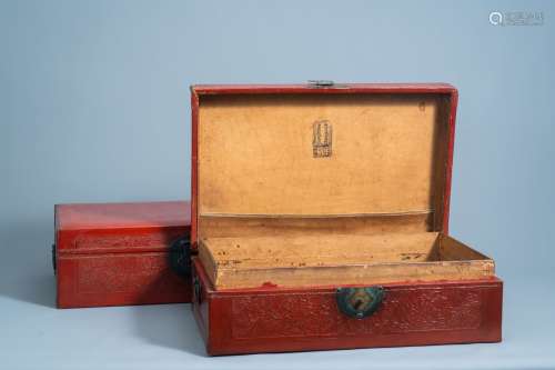 A pair of Chinese partly red lacquered leather travel trunks...