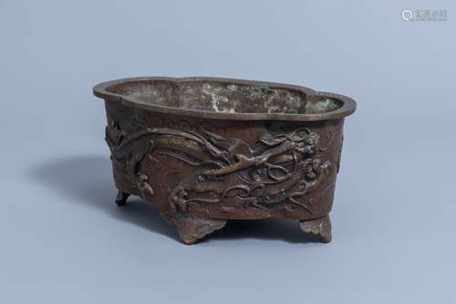 A Japanese four-lobed bronze 'dragon and phoenix' jardiniere...