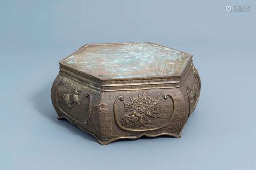 A Japanese bronze hexagonal base with floral design and shis...