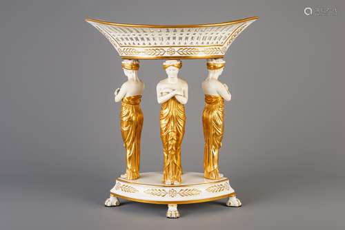 A French gilt parcel-biscuit porcelain centrepiece basket wi...