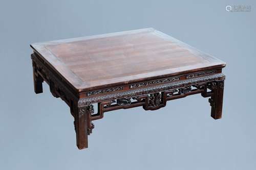 An rectangular Chinese carved wooden coffee table with glass...