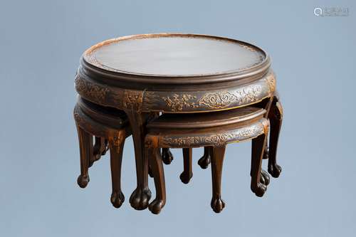 A Chinese wooden coffee table and four stools with relief de...