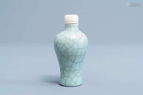 A Chinese celadon crackled glazed snuff bottle with ivory st...