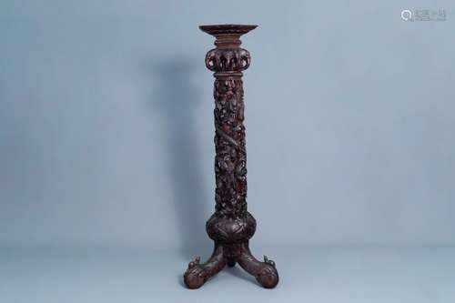 A Chinese or Vietnamese carved wooden column with a dragon a...