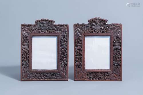 A pair of Chinese carved wooden frames with animals and flow...