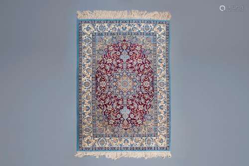 An Oriental rug with floral design, wool and silk on cotton,...