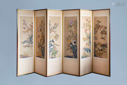 A Chinese six-fold painted silk room divider with birds on b...