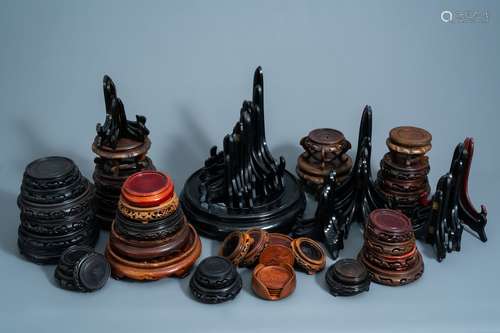 A collection of Chinese carved wooden stands and plate holde...