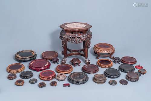 A collection of Chinese wooden stands and a carved wooden st...