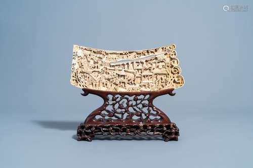 A Chinese richly carved ivory plaque with an animated city v...