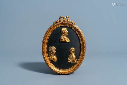 A French red copper plaque with three gilt profile busts of ...