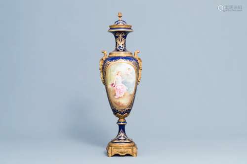 A French gold layered blue ground vase and cover with a love...