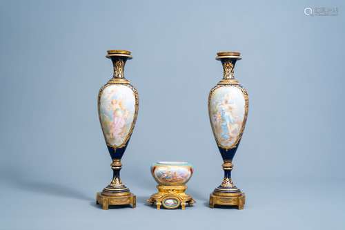 A pair of French Sevres style gold layered blue ground vases...